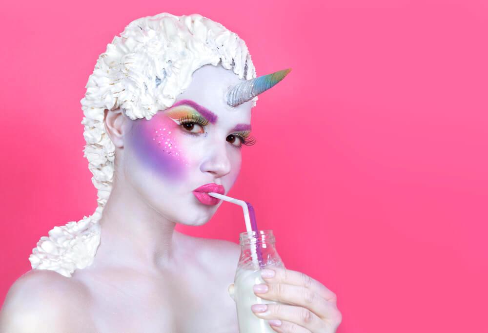 Woman with ethereal unicorn makeup and white hair 