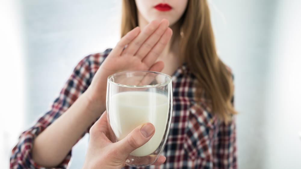 Woman refusing glass of milk 