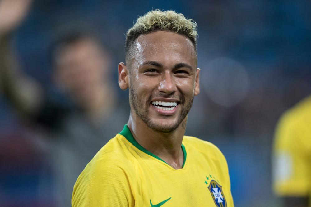 Neymar on the football pitch smiling
