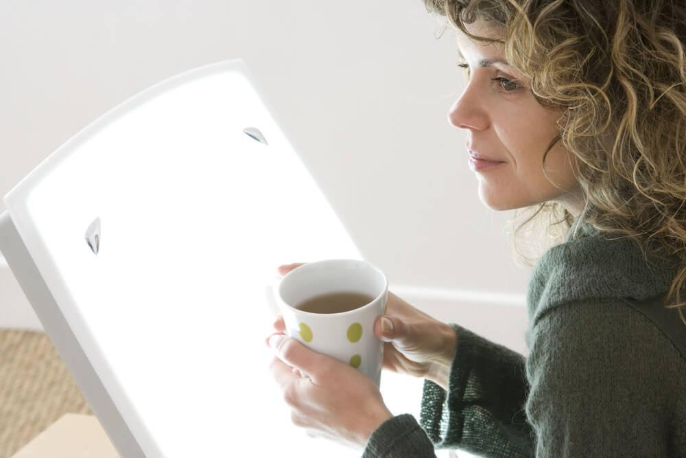 Woman using SAD light box