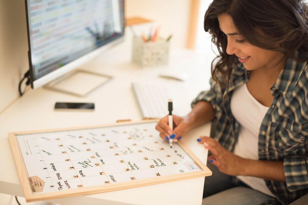 Woman writing on calendar