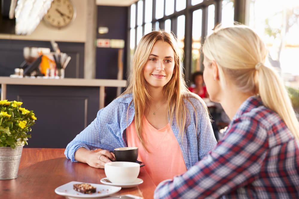 Two friends talking in cafe