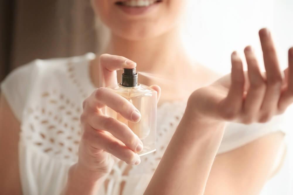 Spraying perfume on wrist