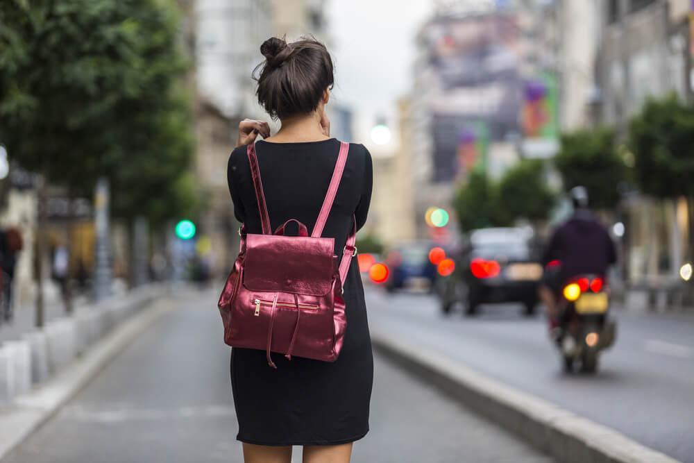 Woman with metallic backpack