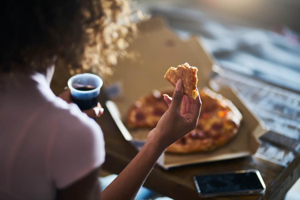 Woman eating pizza