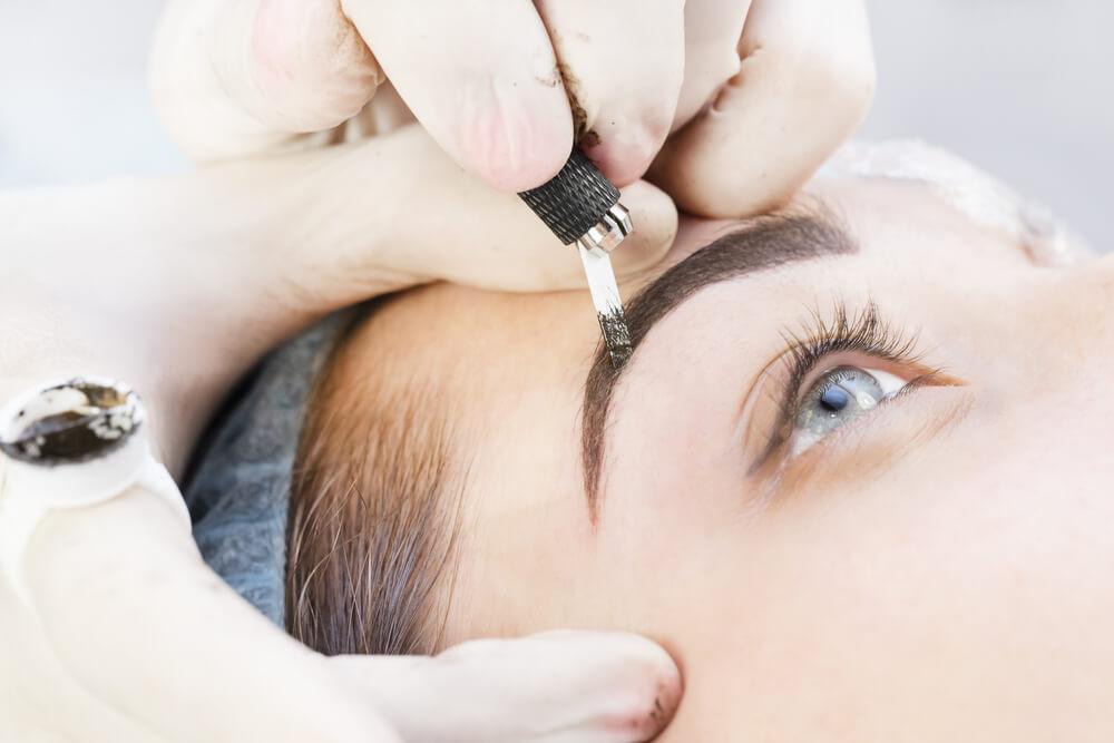 Woman having microblading treatment