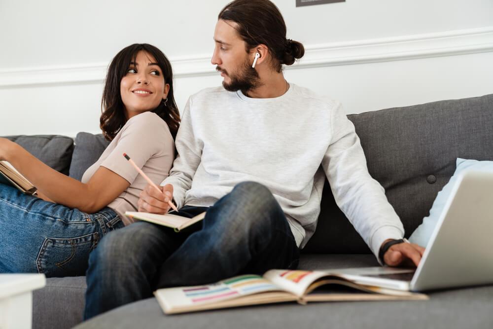 Couple on sofa working