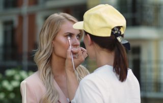 Makeup artist applying makeup to celebrity