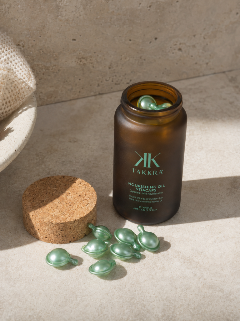 Open bottle of Takkra hair oil capsules for review